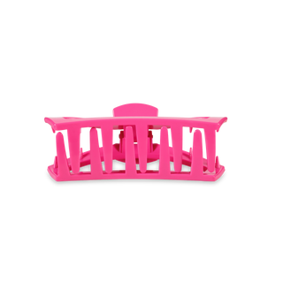 Bright pink open hair clip with curved design and ventilated slats for secure hair styling.