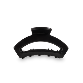 Black curved hair claw clip with teeth for securing hair, shown from side angle