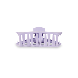 Clear plastic hair clip with curved design and gripping teeth for securing hair