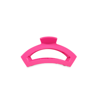 Pink curved hair clip with open design and grip teeth for securing hair