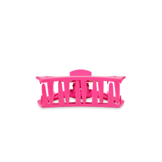 Pink open hair clip with slotted design for sectioning hair during styling