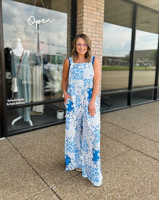 Woman wearing Haptics Patchwork Petals Wide Leg Overalls with floral print outside a boutique.