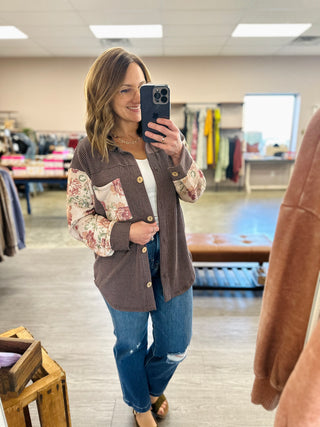 Woman wearing Haptics Petals & Waves Button Down Top with floral sleeves and jeans in boutique.