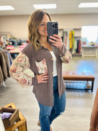 Woman wearing Haptics Petals & Waves Button Down Top with floral sleeves and ribbed body, mirror selfie.