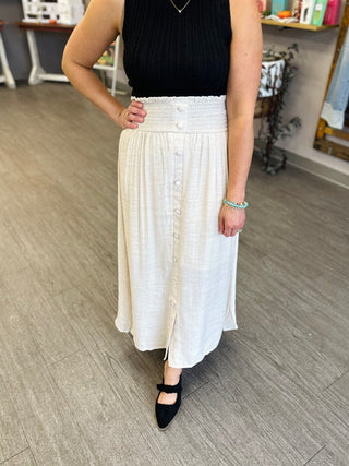 Blu Pepper midi skirt with smocked waistband, button-front detail, and flowy linen-look fabric.