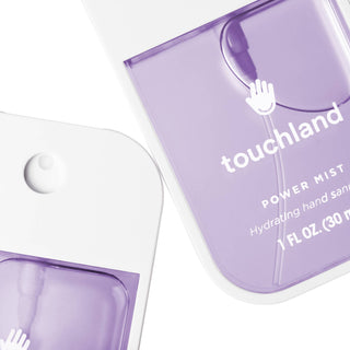 Touchland Power Mist hydrating hand sanitizer spray bottles in translucent purple on white background.