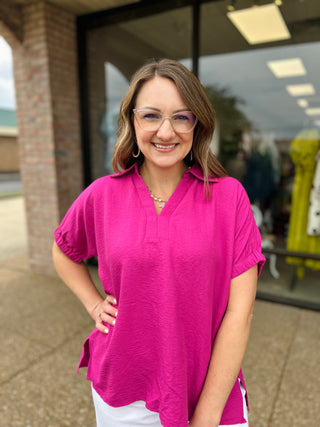 Woman wearing STACCATO Radiant Edge Collared Blouse, smiling outdoors in front of modern building storefront.