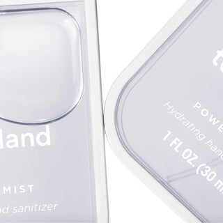 Clear transparent bottles of Touchland hand sanitizer with minimalist white text labeling