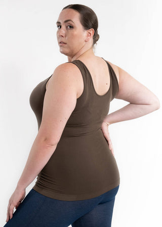 Woman wearing olive green reversible cami tank top with jeans, showing back view and fit.