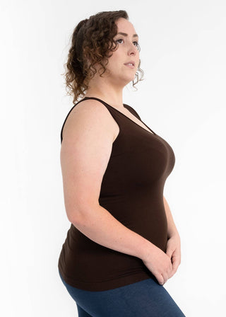 Woman wearing brown reversible cami tank top with keyhole neckline detail in side profile pose.
