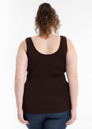 Woman wearing black sleeveless tank top and jeans, shown from behind against white background
