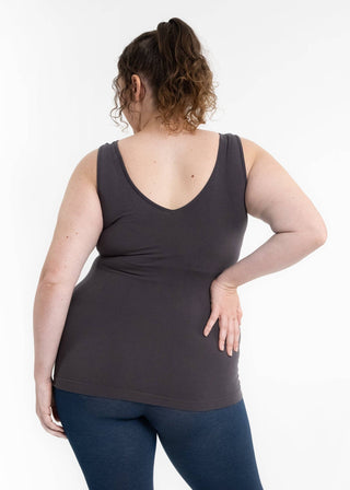 Back view of woman wearing dark fitted reversible cami tank top with jeans
