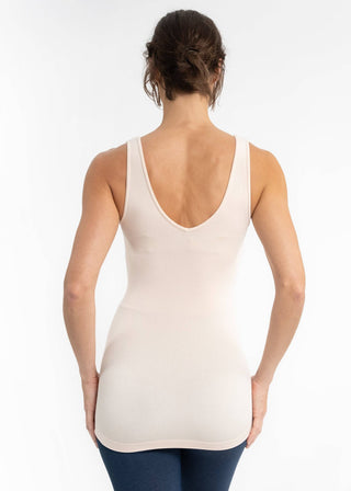 Woman wearing light colored reversible cami top with deep V-back, viewed from behind