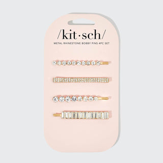 Four rhinestone bobby pins with different crystal arrangements on pink packaging card