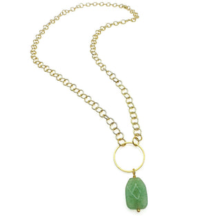 Alegria Accessories Rio Necklace with gold chain links, circular ring pendant, and carved stone drop.