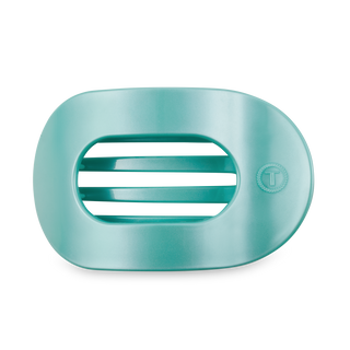 Round flat hair clip with ribbed grip pattern in turquoise color on white background