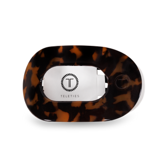 TELETIES round flat hair clip with tortoiseshell pattern and brand logo on white background