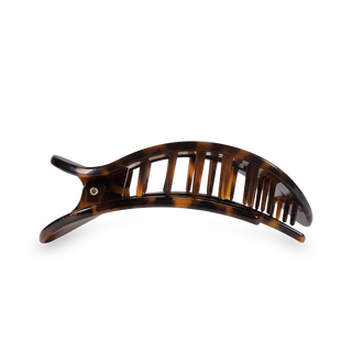 Medium tortoise shell hair clip with curved design and open slat pattern for secure styling.