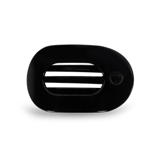 Black round flat hair clip with oval opening and textured grip surface