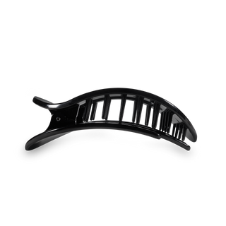 Black curved hair clip with vertical slat design on transparent background