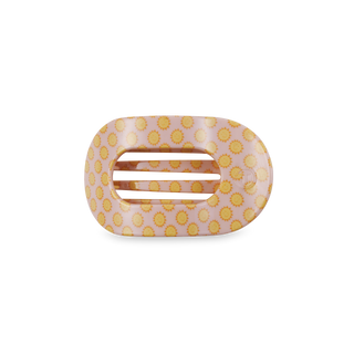 Round flat hair clip with pink background and yellow sun pattern design