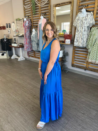 Woman wearing Royal Horizon Maxi dress by Skies Are Blue in clothing boutique setting