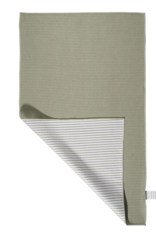 Sage green kitchen towel with folded corner showing striped reverse pattern on white background