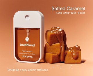 Touchland Power Mist hand sanitizer spray bottle beside stacked caramel candies drizzled with caramel sauce and sea salt.
