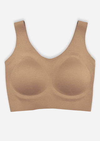 Nude seamless wireless bra with V-neck design and comfortable molded cups on white background