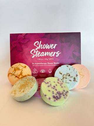 Colorful aromatherapy shower steamers displayed with purple packaging box containing six essential oil bath bombs