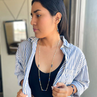 Woman wearing Alegria Accessories Skye Bracelet with matching necklace and earrings in blue and gold.
