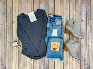Slate gray long sleeve tee styled with jeans, ankle boots, and accessories on wooden background