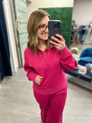 Woman wearing Jodifl Soft Summit Set taking mirror selfie in retail store