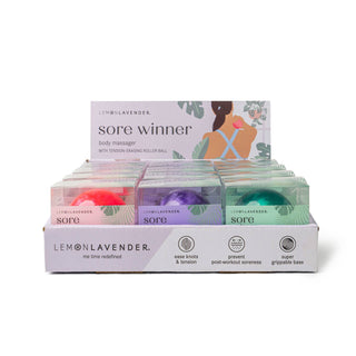 Display box of Lemon Lavender Sore Winner body massagers with tension-erasing roller balls in various colors.