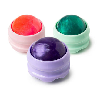 Three colorful sphere-shaped Sore Winner Body Massagers in translucent containers on white background.