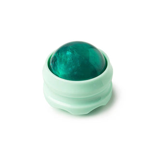 Green massage ball in translucent shell-shaped holder for body relief and muscle tension