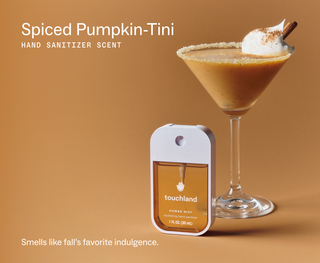 Touchland Power Mist hand sanitizer beside a creamy pumpkin martini with whipped cream and cinnamon.