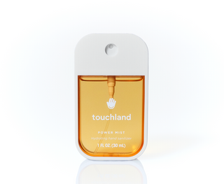 Touchland Power Mist hydrating hand sanitizer spray bottle with amber liquid, 1 fl oz.