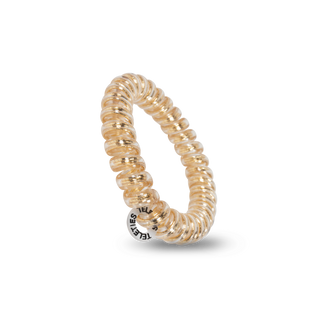 TELETIES spiral hair coil in translucent gold color against black background