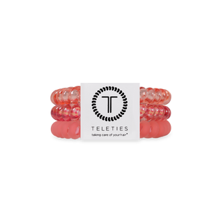TELETIES spiral hair coils in coral pink color, packaged in clear plastic container with brand label