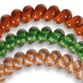 Three strands of spiral hair coil ties with patterned, translucent designs arranged on black background.