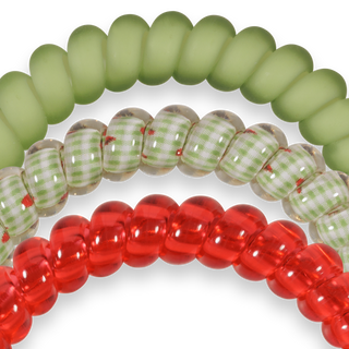 Three spiral hair coils in different colors and patterns displayed on black background
