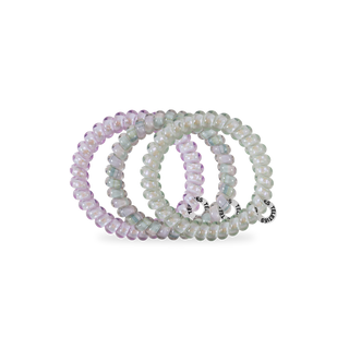 Set of spiral hair coils in translucent iridescent colors displayed on clear packaging