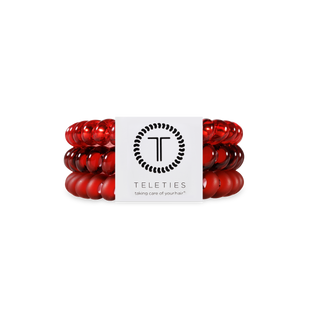 Red spiral hair coils displayed with TELETIES branding and logo on white background.