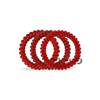 Red spiral hair coils arranged in overlapping circles with branded tags attached