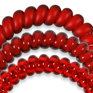 Red spiral hair coils arranged in curved formations against black background showing elastic telephone cord design.