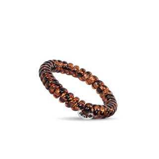 TELETIES spiral hair coils in tortoiseshell pattern with clear accent bead on black background