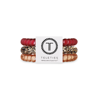 TELETIES spiral hair coils in various colors and patterns displayed around brand logo