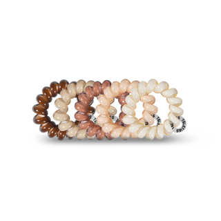 TELETIES spiral hair coils in neutral nude tones displayed on black background