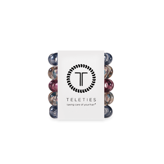 TELETIES spiral hair coils in various colors displayed around branded packaging with logo